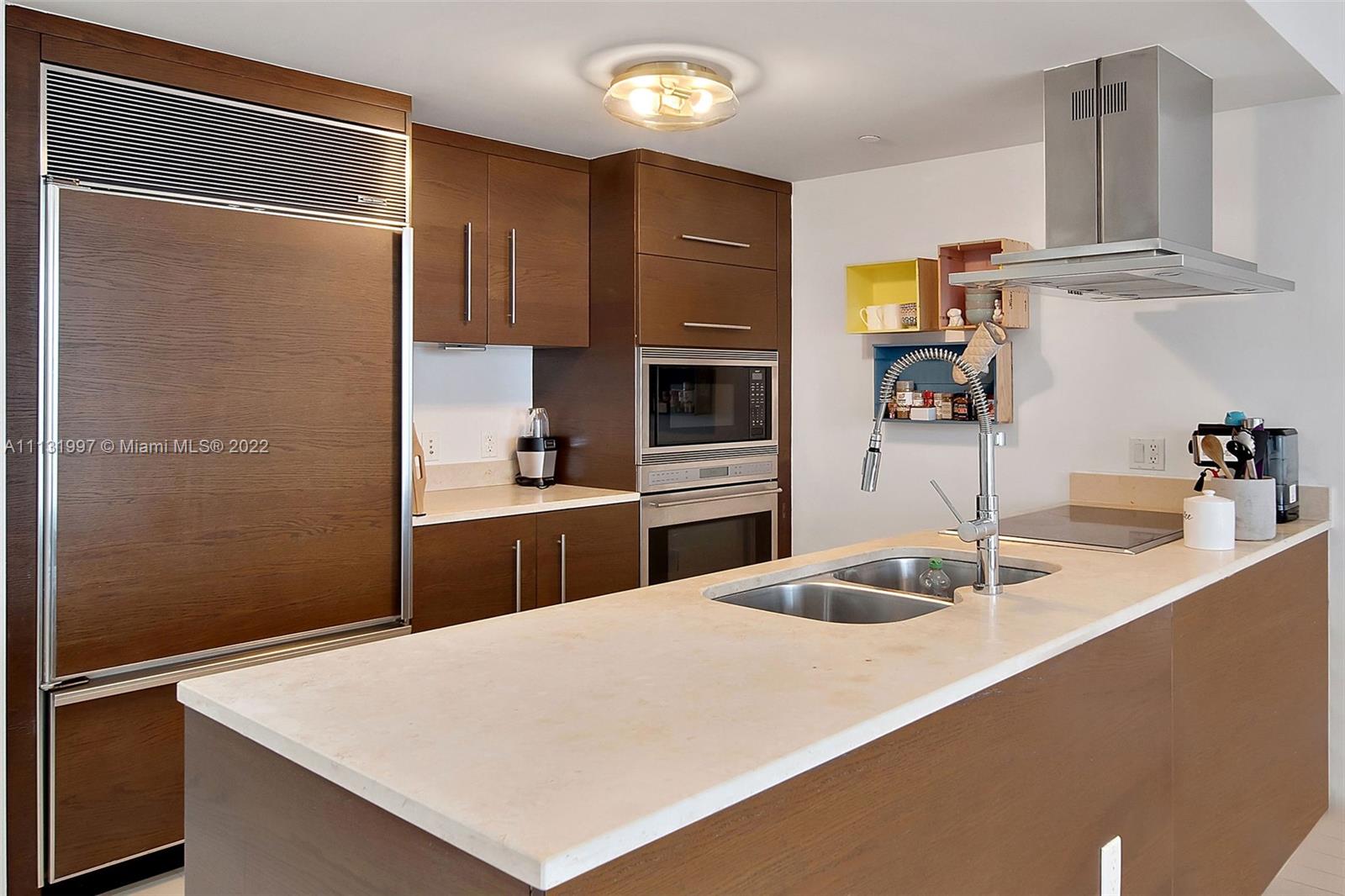 495 Brickell Avenue, Unit 3107 Miami, FL 33131 - Photo 4 of 41 a kitchen with granite countertop a sink stainless steel appliances and cabinets