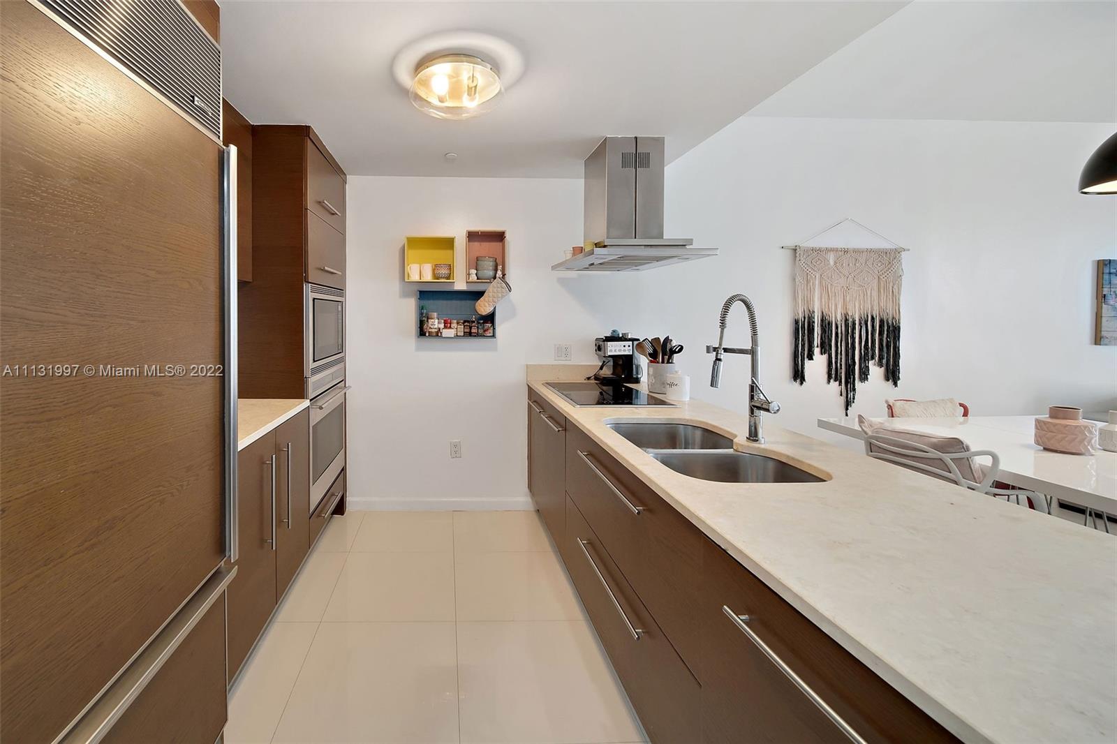 495 Brickell Avenue, Unit 3107 Miami, FL 33131 - Photo 5 of 41 a kitchen with a sink and a refrigerator