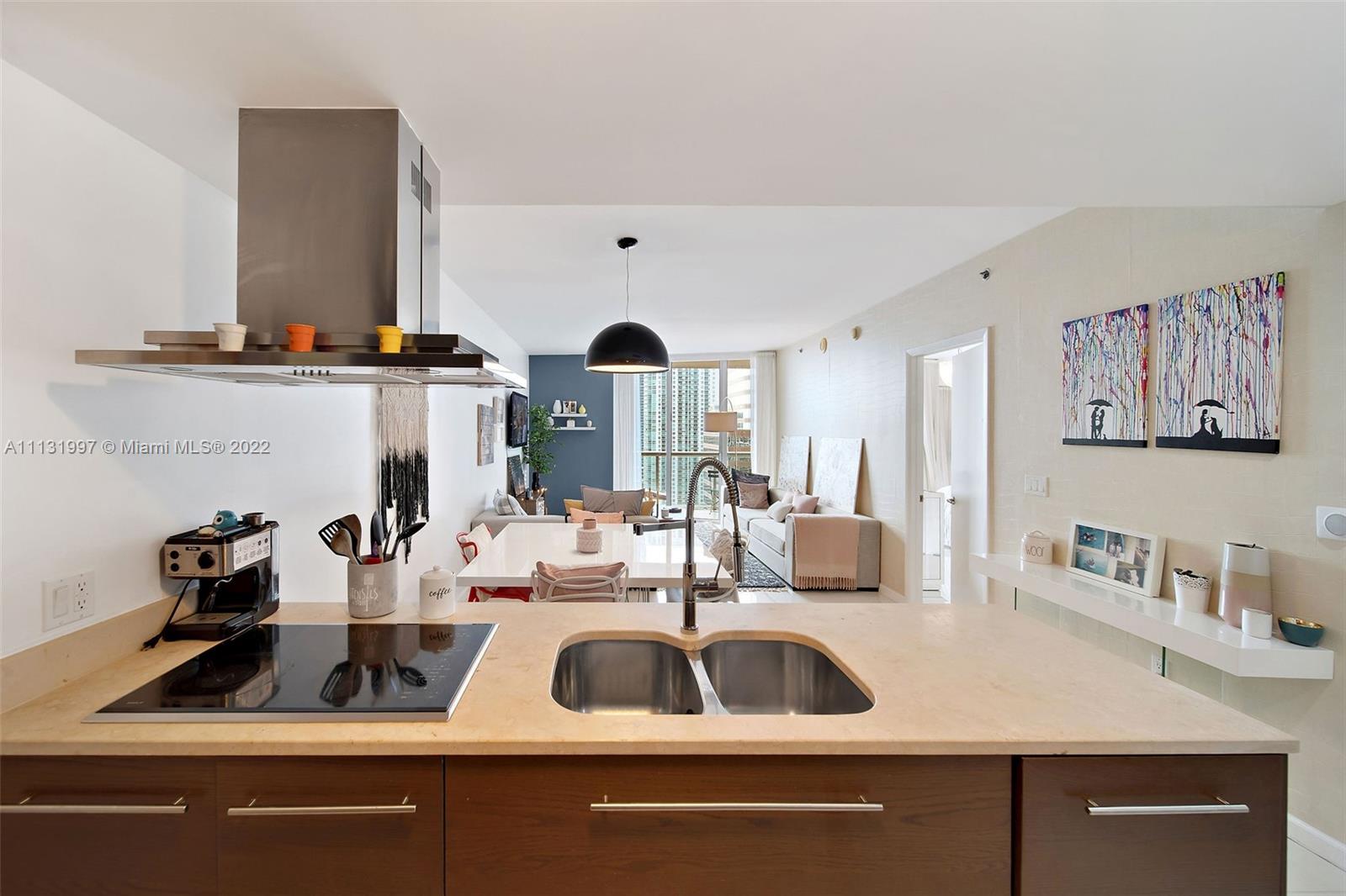 495 Brickell Avenue, Unit 3107 Miami, FL 33131 - Photo 6 of 41 a kitchen with a sink cabinets and a window