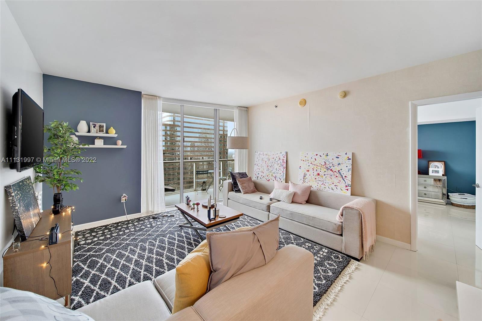 495 Brickell Avenue, Unit 3107 Miami, FL 33131 - Photo 9 of 41 a living room with furniture window and a flat screen tv