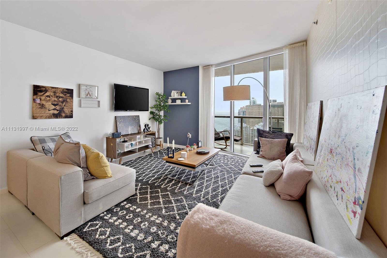 495 Brickell Avenue, Unit 3107 Miami, FL 33131 - Photo 10 of 41 a living room with furniture and a flat screen tv