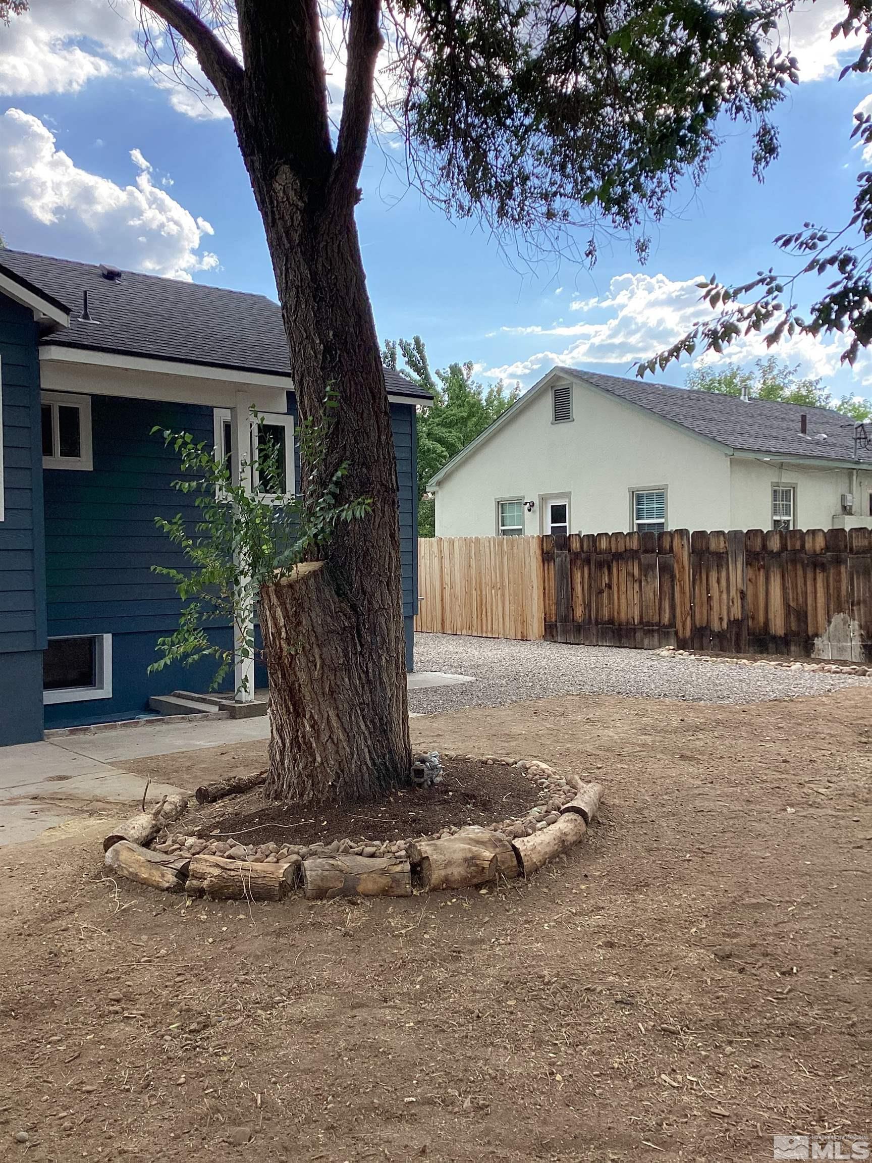 235 Caliente Street, Unit CALIENTE ST 1 & 2 Reno, NV 89509 - Photo 16 of 25 a view of a backyard with a tree
