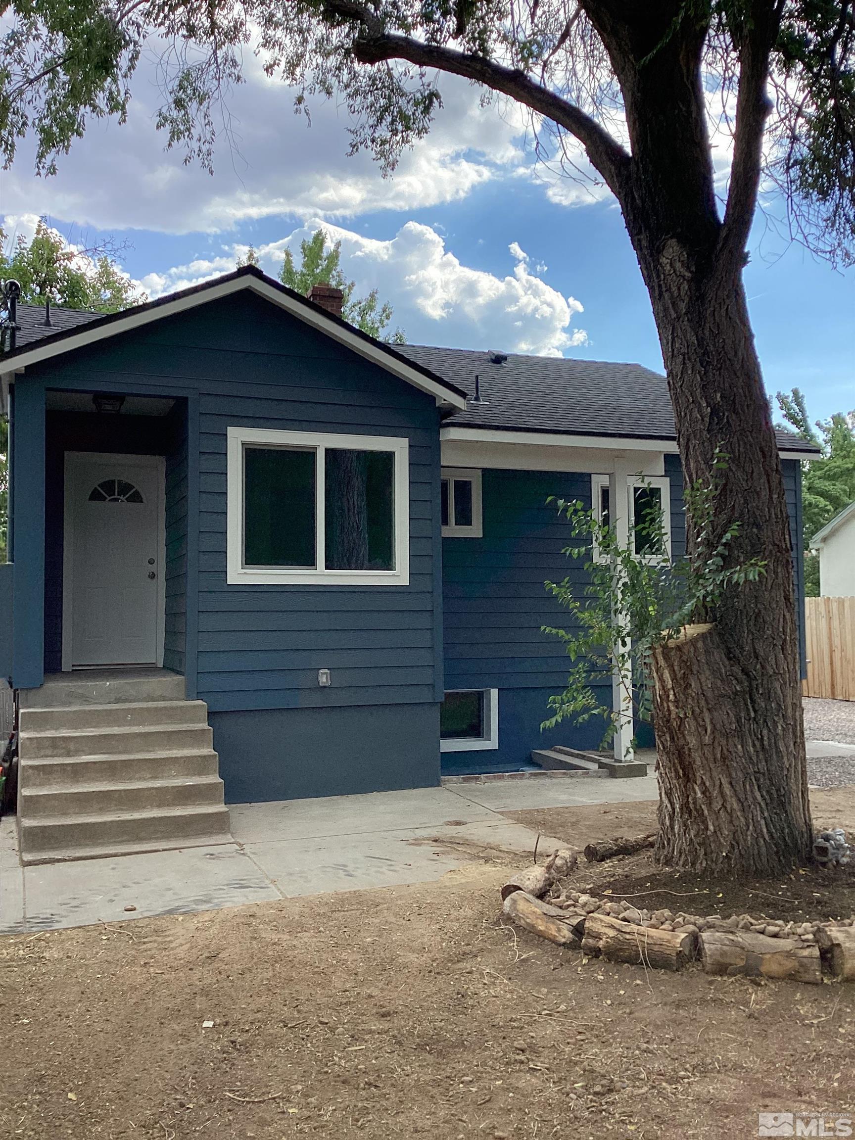 235 Caliente Street, Unit CALIENTE ST 1 & 2 Reno, NV 89509 - Photo 17 of 25 a front view of a house with a yard