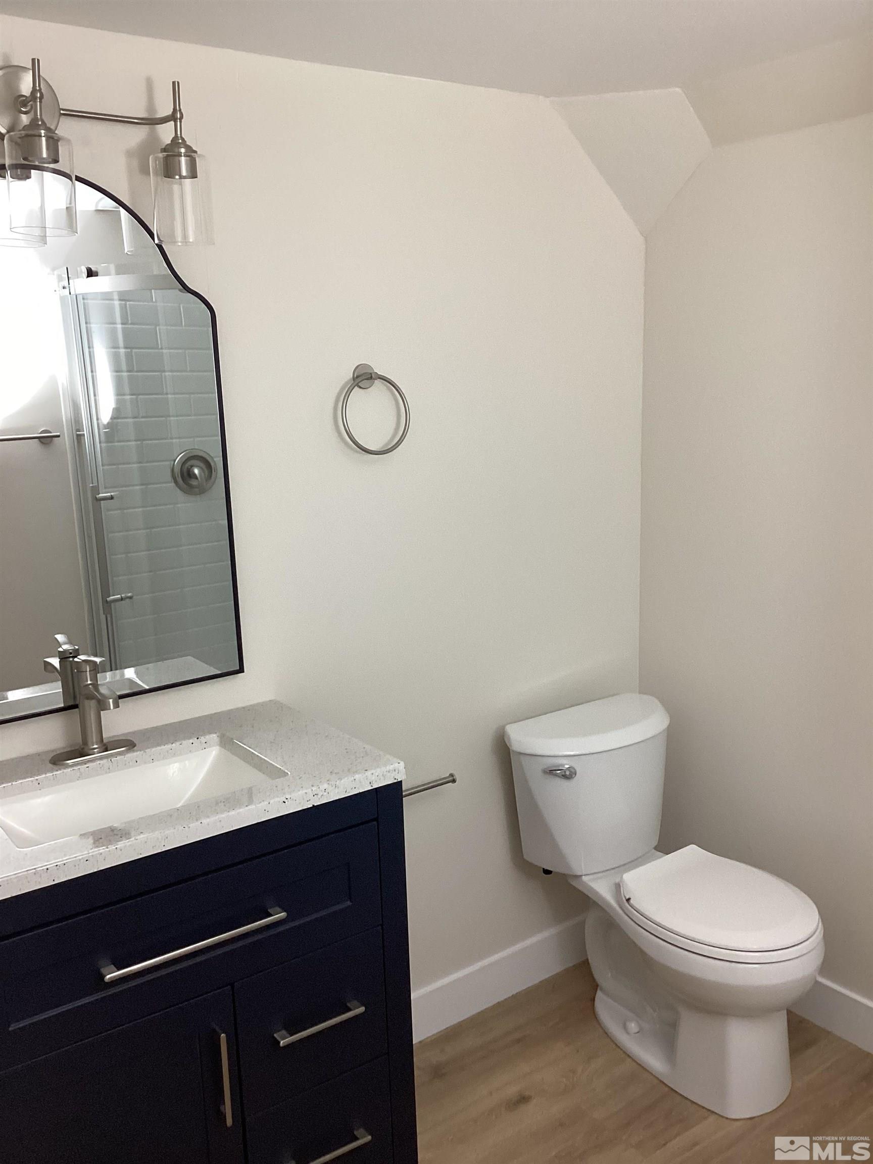 235 Caliente Street, Unit CALIENTE ST 1 & 2 Reno, NV 89509 - Photo 25 of 25 a bathroom with a toilet sink and mirror