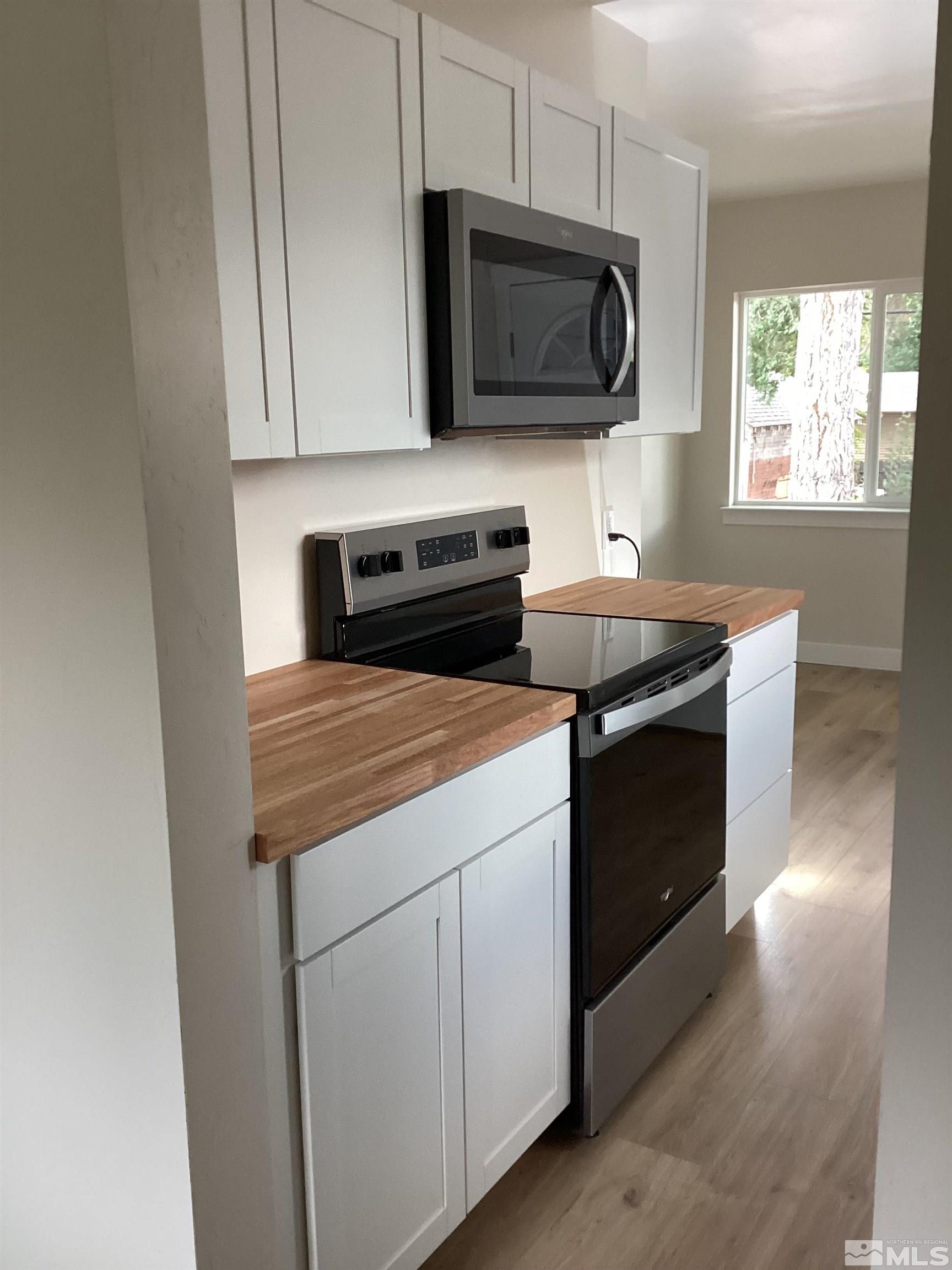 235 Caliente Street, Unit CALIENTE ST 1 & 2 Reno, NV 89509 - Photo 8 of 25 a kitchen with a stove microwave and sink