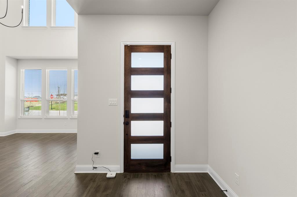3916 Keya Drive Prosper, TX 75078 - Photo 4 of 28 an empty room with wooden floor and window