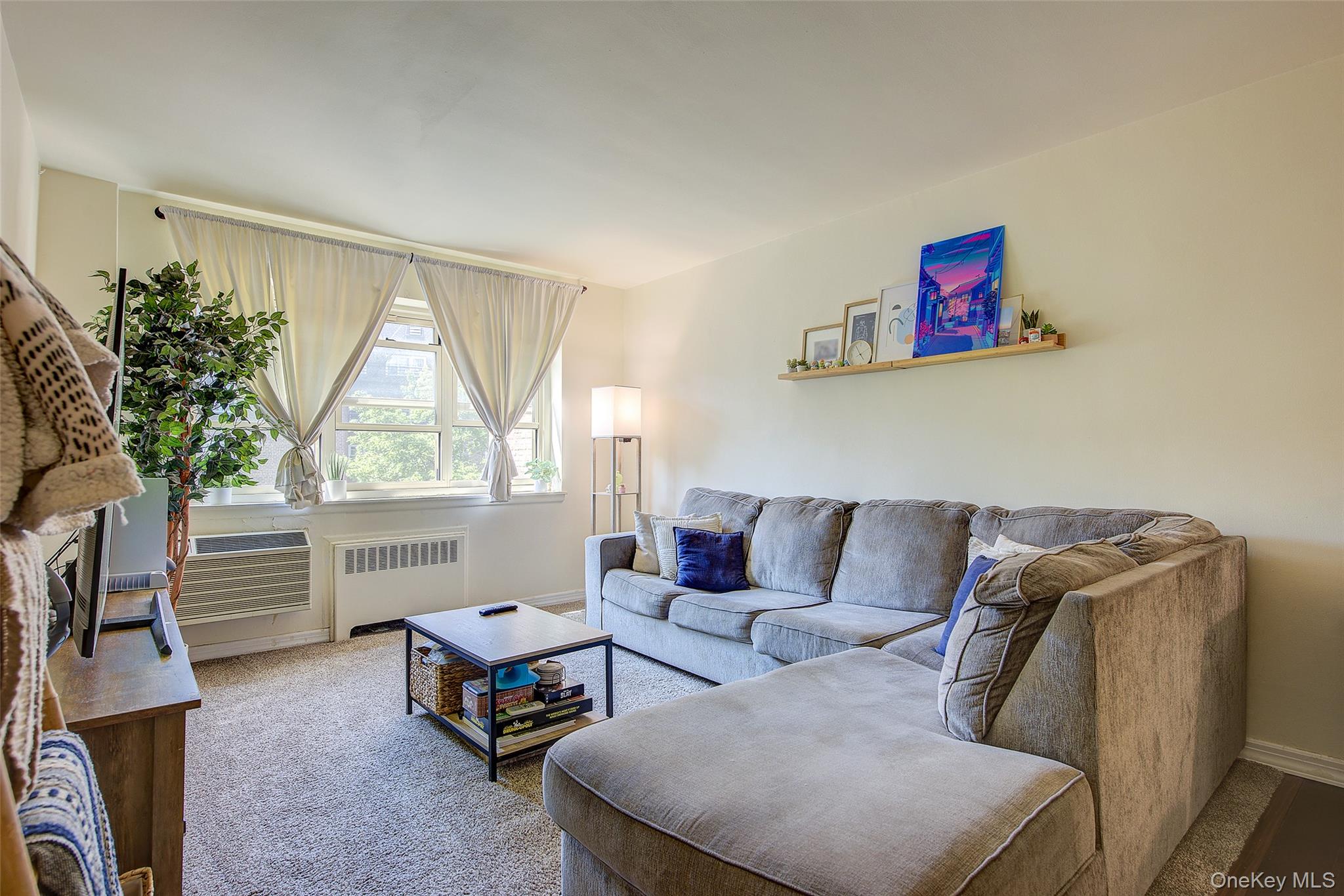 144-60 Gravett Road, Unit 4J Queens, NY 11367 - Photo 12 of 38 a living room with furniture and a window