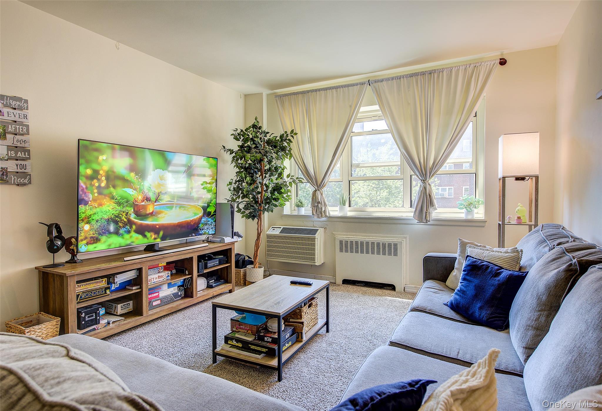144-60 Gravett Road, Unit 4J Queens, NY 11367 - Photo 13 of 38 a living room with furniture and a flat screen tv