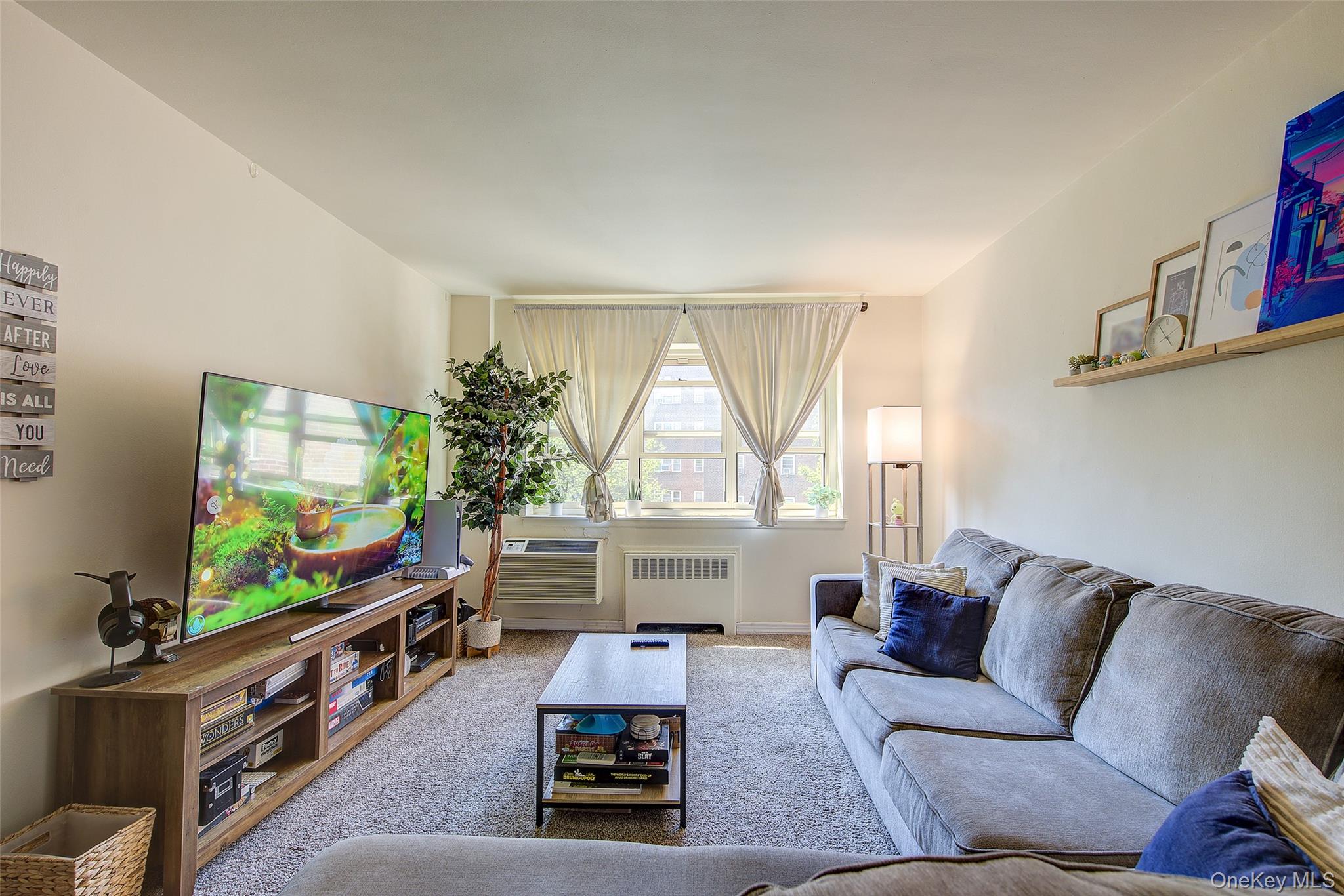 144-60 Gravett Road, Unit 4J Queens, NY 11367 - Photo 14 of 38 a living room with furniture and a flat screen tv