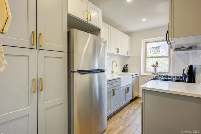 a kitchen with white cabinets and white appliances