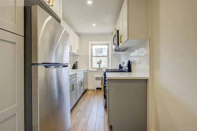 a kitchen with white cabinets and white appliances