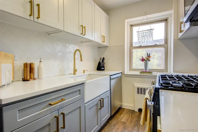 a kitchen with a sink and a stove top oven