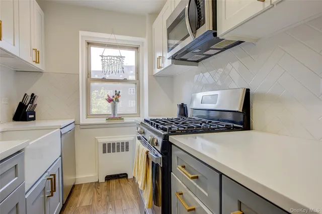 a kitchen with stainless steel appliances a stove a sink and a refrigerator