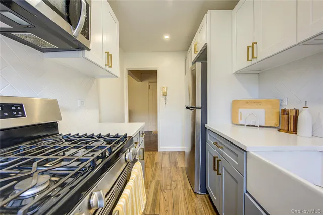 a kitchen with wooden floor stove and refrigerator