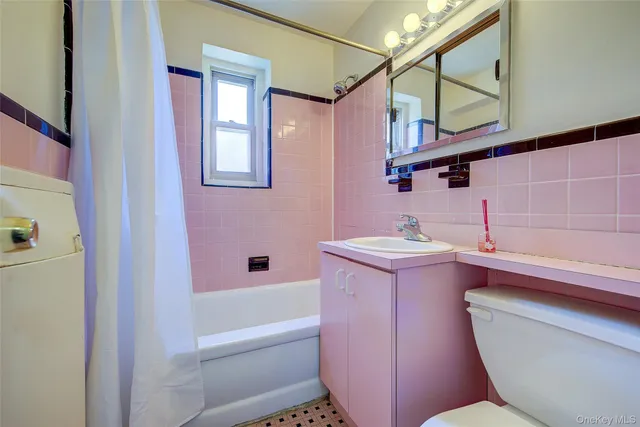 a bathroom with a sink a toilet and bathtub