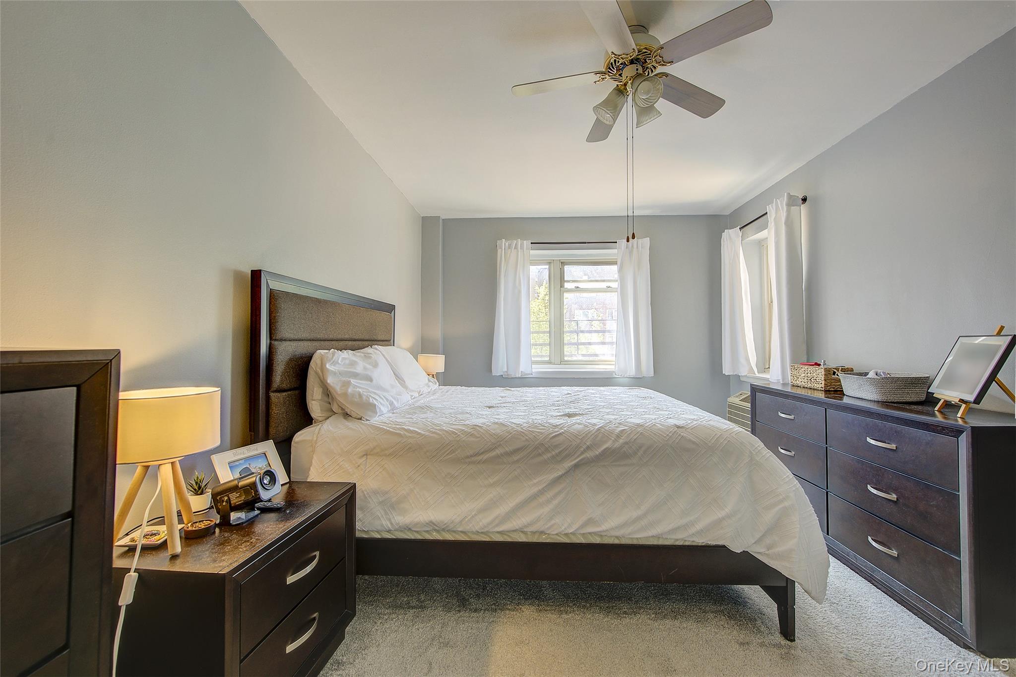 144-60 Gravett Road, Unit 4J Queens, NY 11367 - Photo 28 of 38 a bedroom with a bed and a chandelier