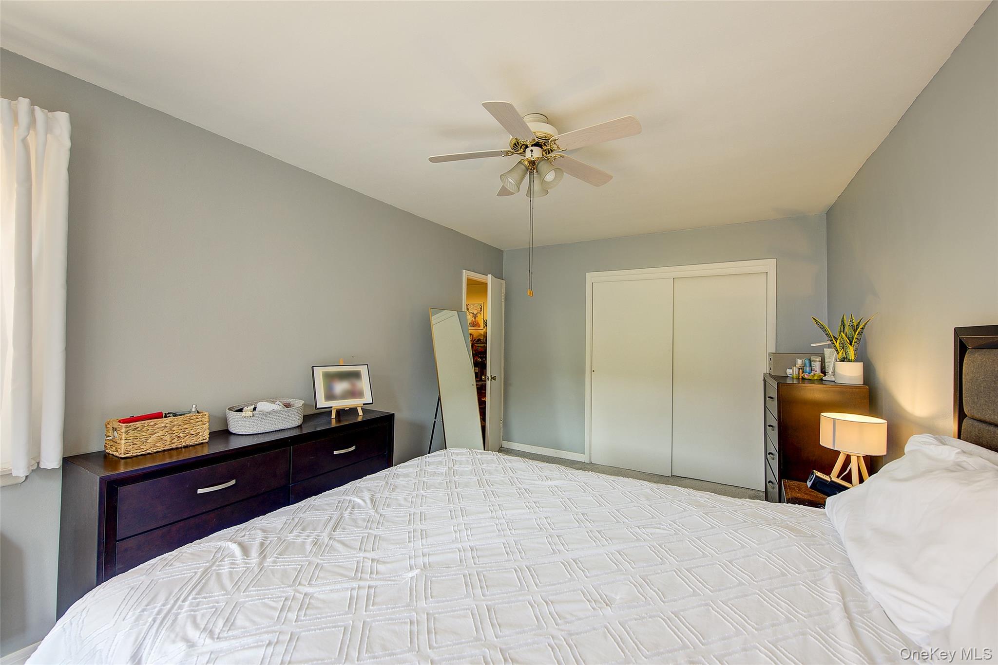 144-60 Gravett Road, Unit 4J Queens, NY 11367 - Photo 31 of 38 a bedroom with a bed and a chandelier