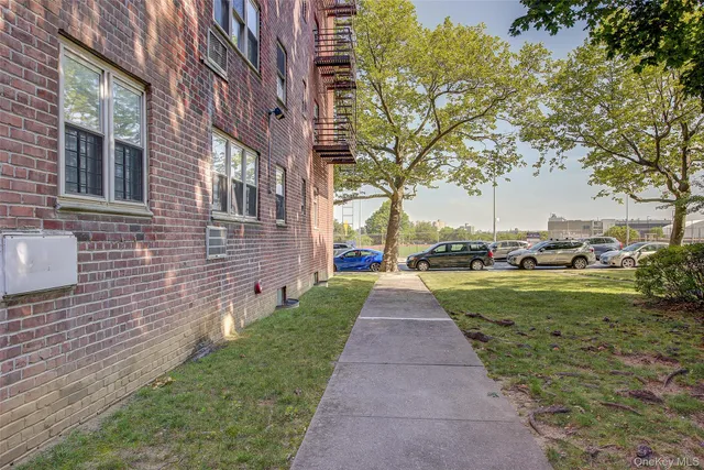 a view of a brick house with a yard