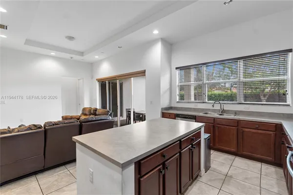 a kitchen with a stove sink and cabinets