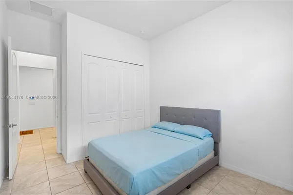 a bedroom with a bed and a shower