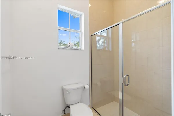a bathroom with a toilet and a shower