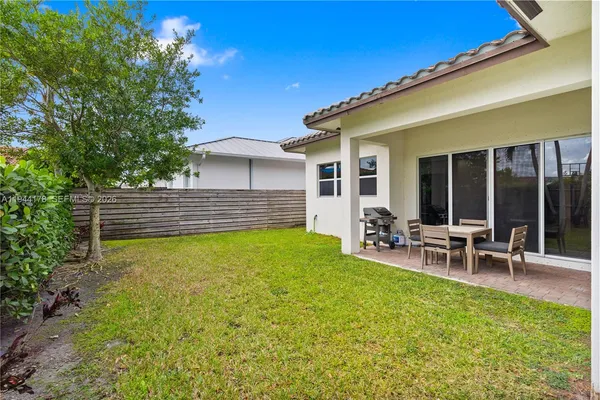 a view of a house with backyard porch and sitting area