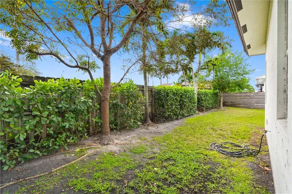 a view of a backyard with potted plants