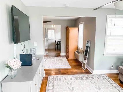 a living room with furniture rug and a flat screen tv