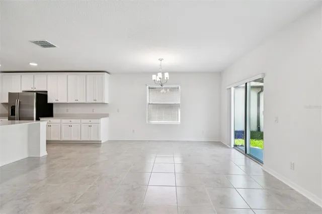 a view of a kitchen with an empty space and a window