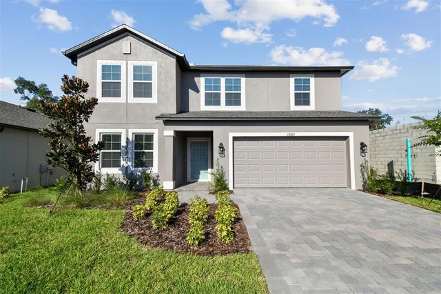 a front view of a house with a yard and garage