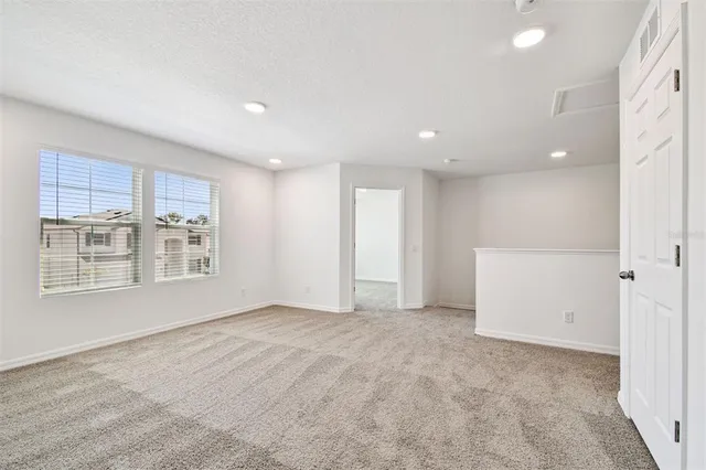 a view of an empty room and closet area