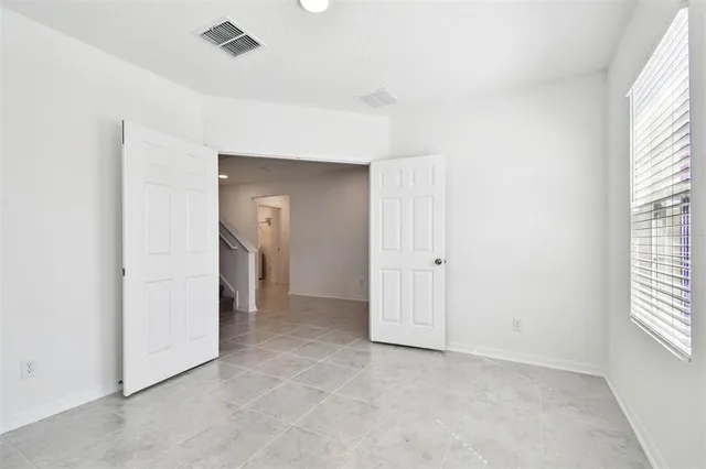 a view of hallway with windows and brick walls