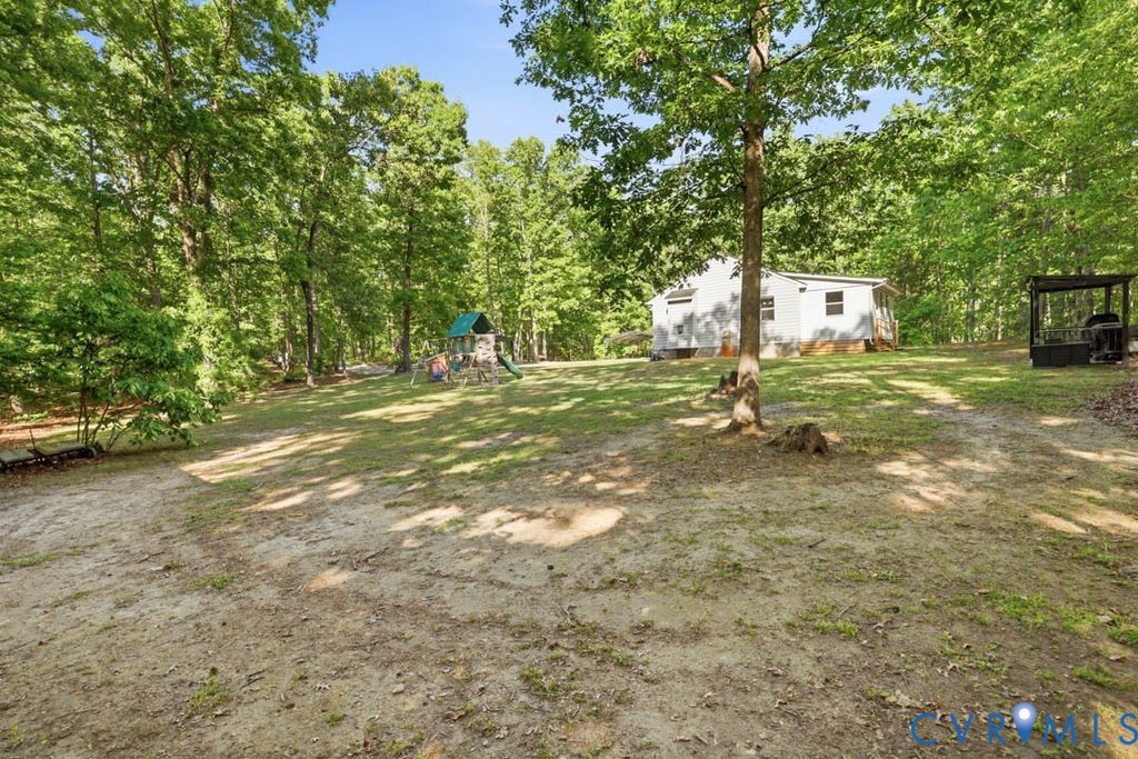5307 St Pauls Church Road Goochland, VA 23063 - Photo 43 of 44 a backyard of a house with barbeque oven table and chairs