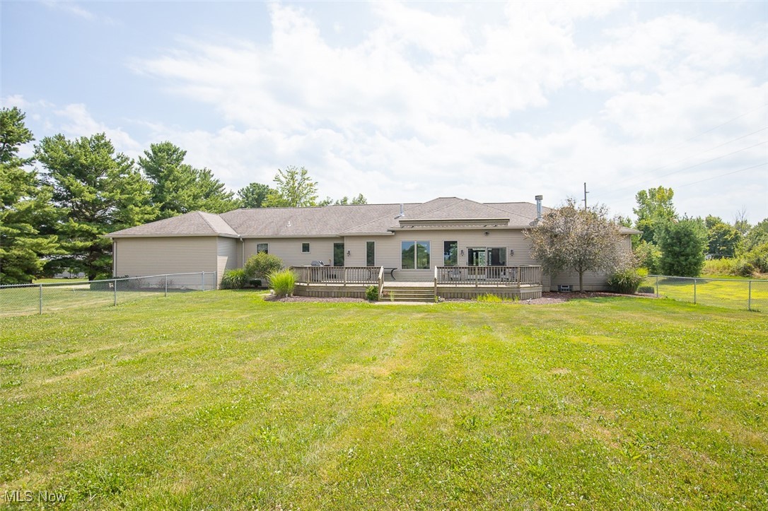9155 Shank Road Litchfield, OH 44253 - Photo 39 of 47 Rear view of property with a fenced backyard and a deck