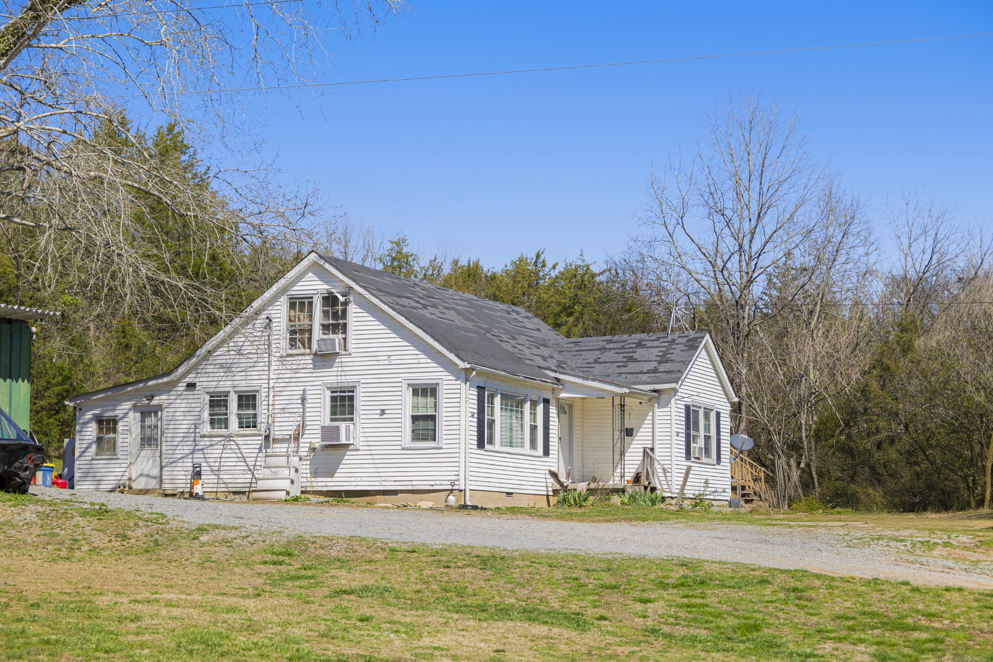30 King Hollow Road Frankewing, TN 38459 - Photo 19 of 49 a view of a white house with a big yard and potted plants in front of it