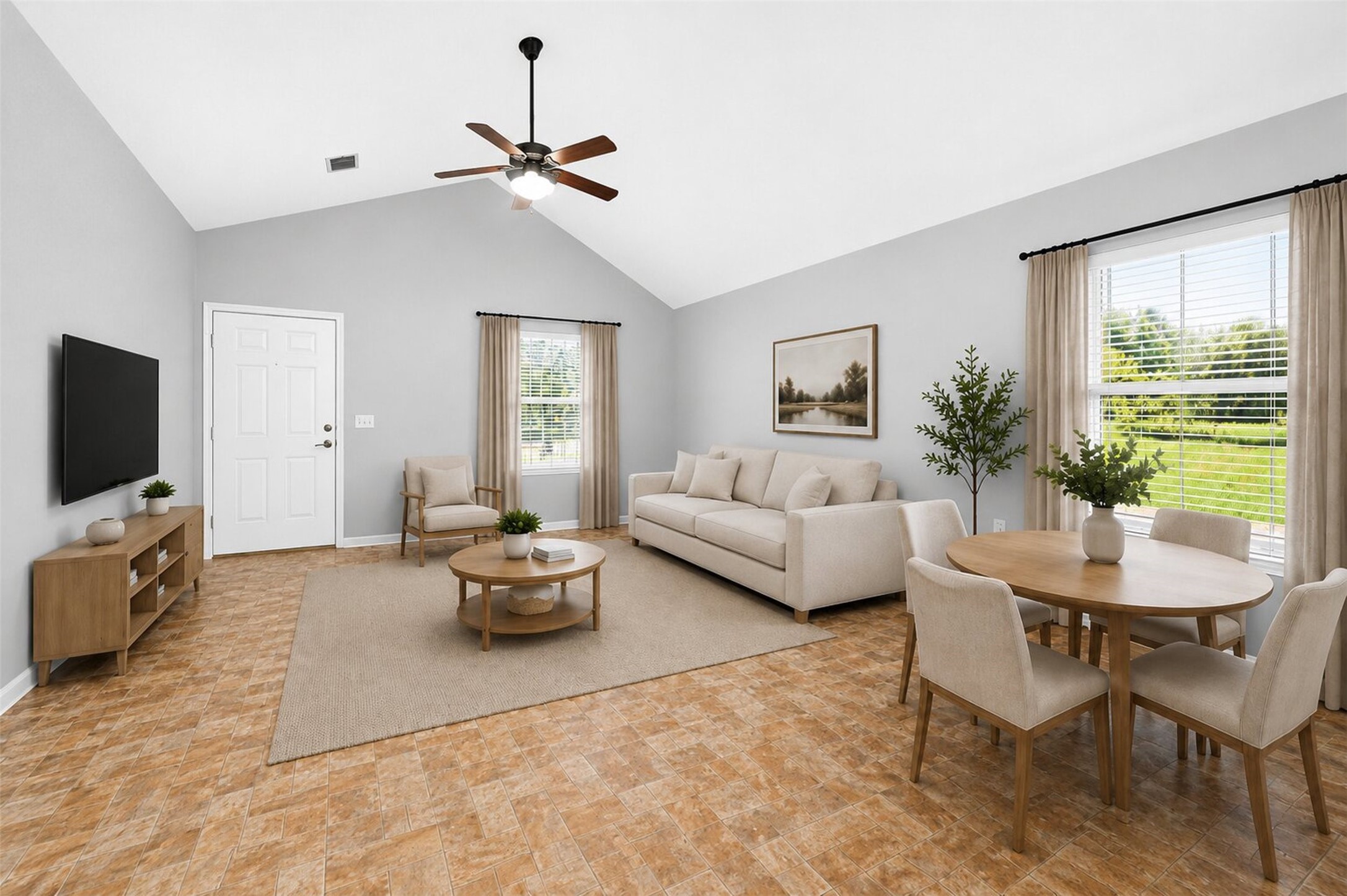 148 Fear Road Winnie, TX 77665 - Photo 5 of 34 This is a bright, open-concept living and dining area with a neutral color palette. It features a comfortable sofa, round dining table, and ample natural light from large windows. The space includes a ceiling fan, modern décor, and a wall-mounted TV, creating a cozy and inviting atmosphere. This room is virtually staged.
