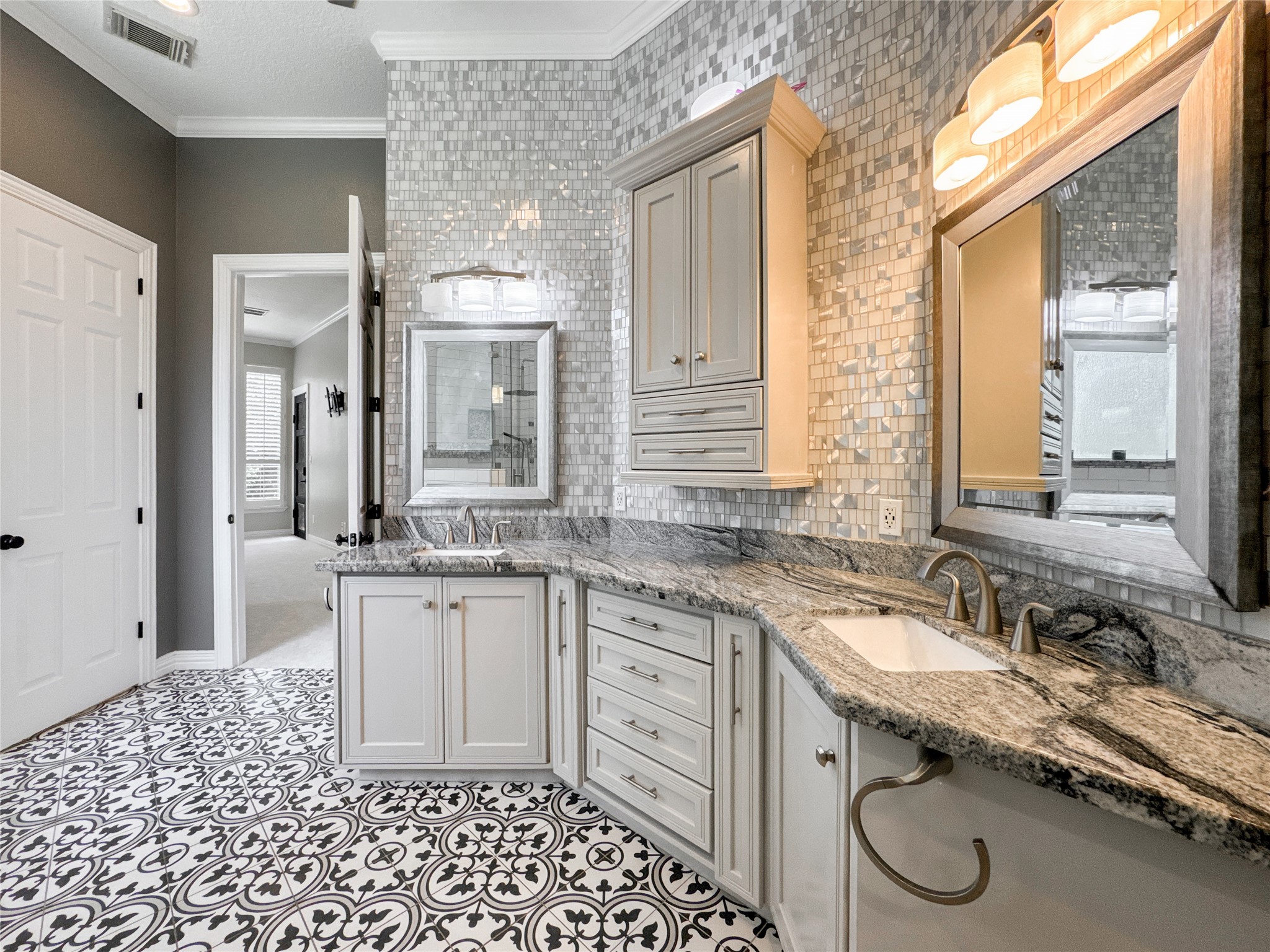 1810 Woerner Road Houston, TX 77090 - Photo 23 of 39 Luxurious primary bath featuring elegant tile flooring, a stunning mosaic accent wall, and a sleek granite countertop with ample cabinetry.