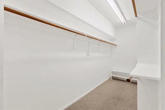 a bathroom with a granite countertop sink a mirror and a shower