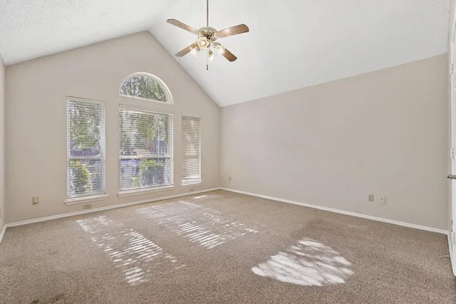 a living room with wooden floor and a fireplace