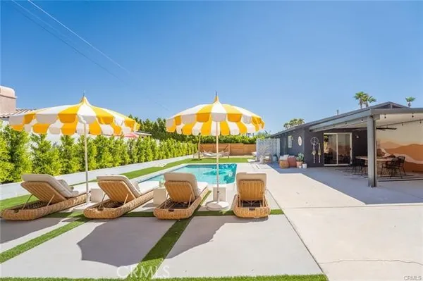 a view of swimming pool with seating space and furniture