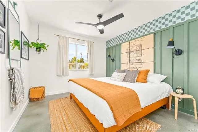 a bedroom with a bed dresser and a window