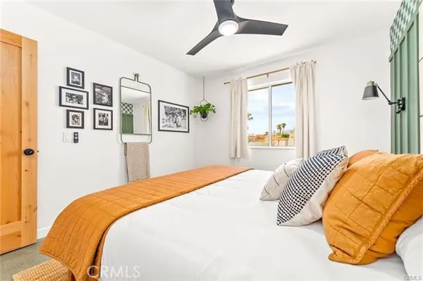 a bedroom with a bed and a painting on the wall