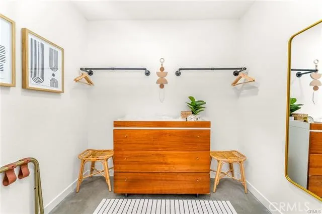 a room with a couch and a potted plant