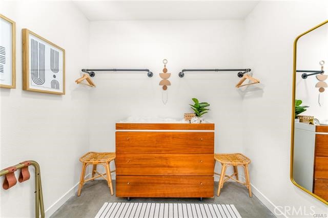 2770 East Ventura Road Palm Springs, CA 92262 - Photo 14 of 27 a room with a couch and a potted plant