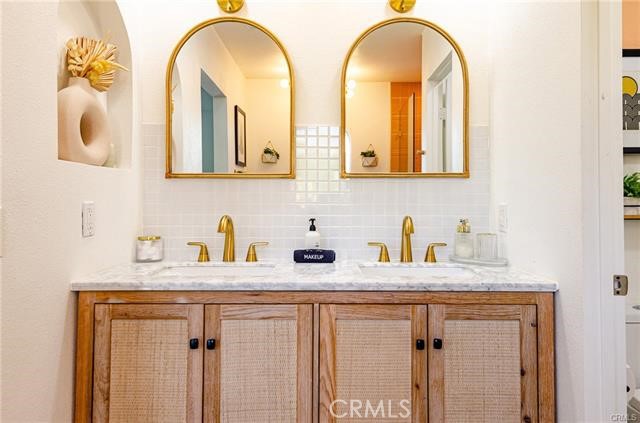 2770 East Ventura Road Palm Springs, CA 92262 - Photo 19 of 27 a bathroom with a granite countertop sink and a mirror