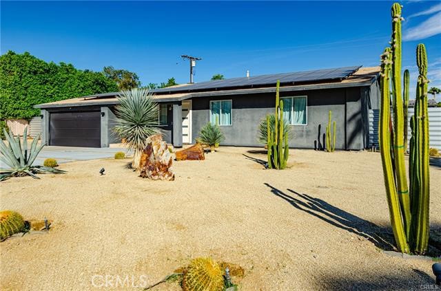 2770 East Ventura Road Palm Springs, CA 92262 - Photo 27 of 27 a view of a swimming pool with a chair and tables in the patio