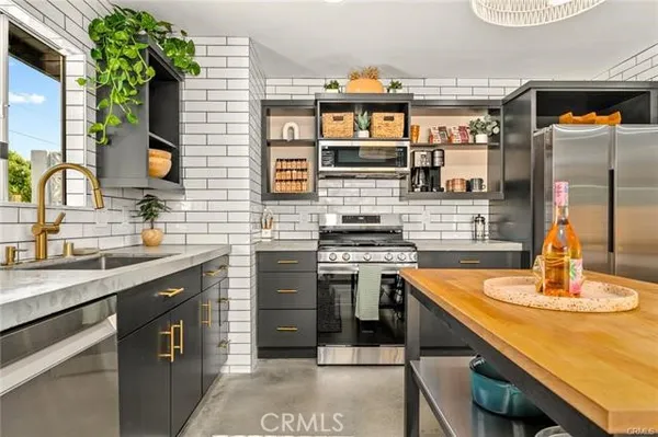 a kitchen with a sink cabinets and appliances