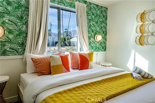 a bedroom with a bed and a window