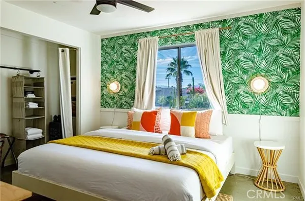 a bedroom with a bed and a window