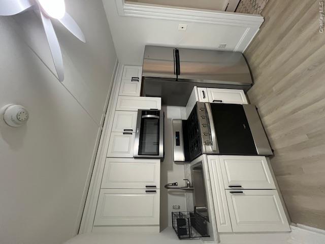 418 Christian Herald Road, Unit 4 Valley Cottage, NY 10989 - Photo 5 of 16 a kitchen with stainless steel appliances granite countertop a refrigerator a stove a sink and white cabinets